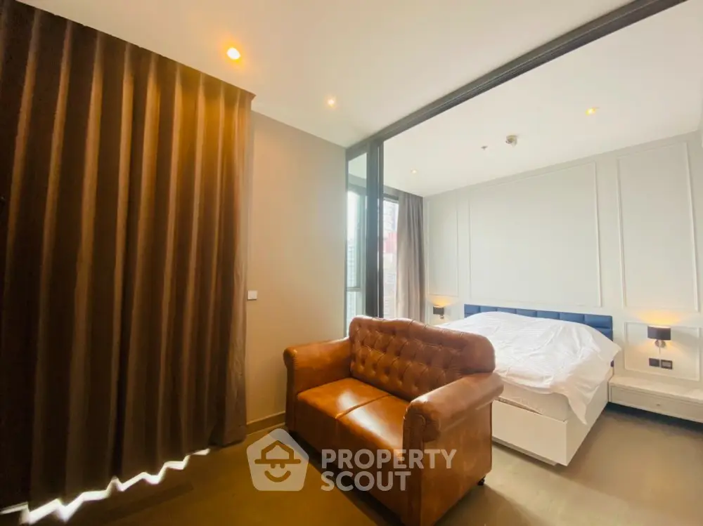 Luxurious bedroom with elegant leather sofa and modern lighting