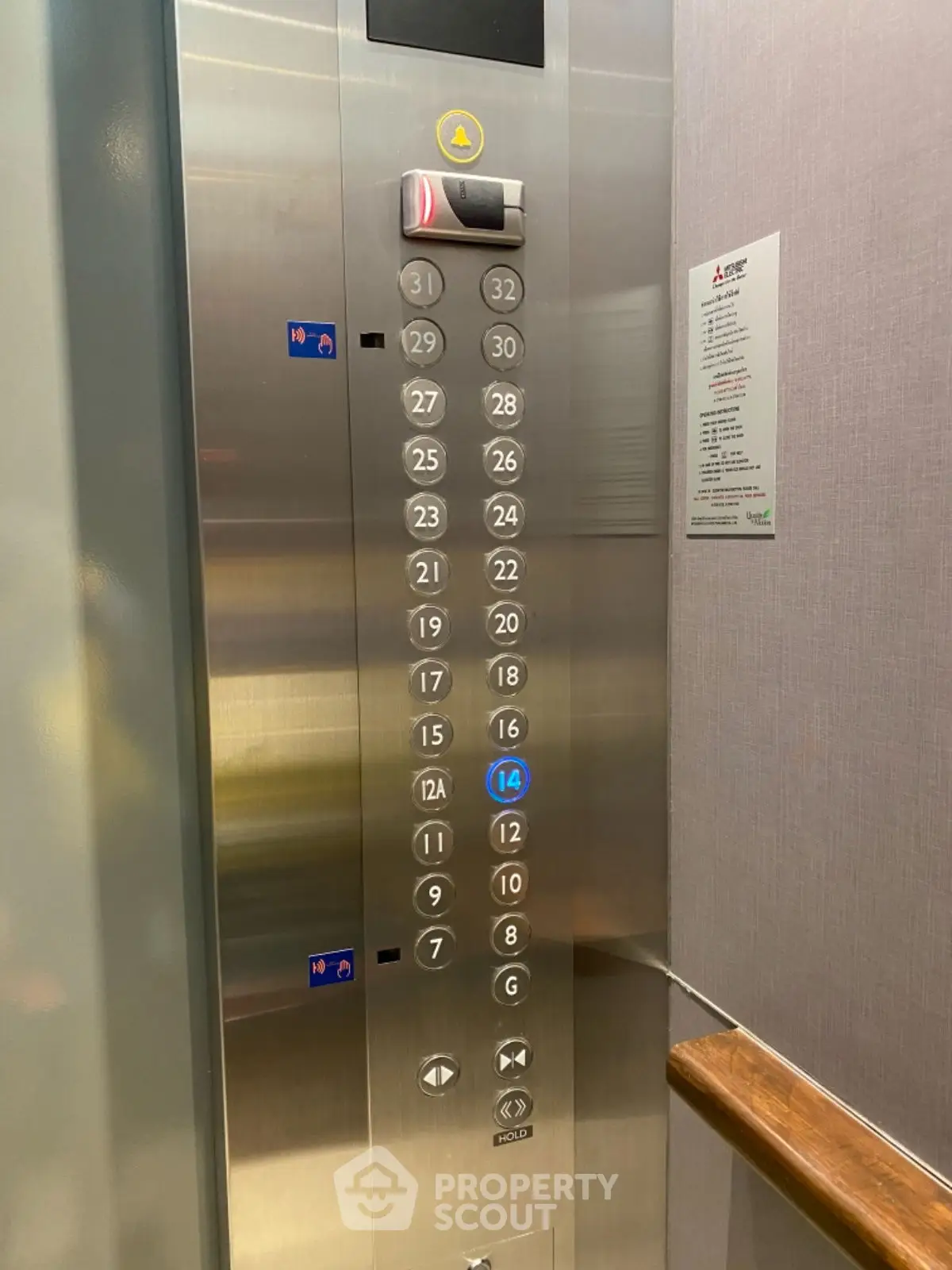 Modern elevator interior with stainless steel panel and floor buttons