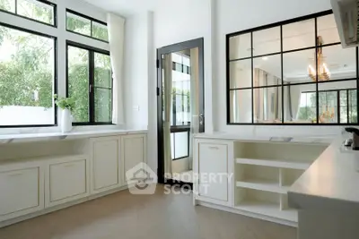 Elegant kitchen with large windows and modern cabinetry