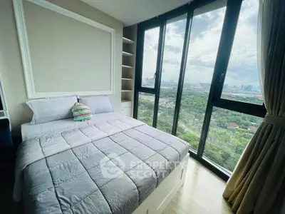 Luxurious bedroom with stunning city view through large windows, featuring modern decor and cozy bedding.