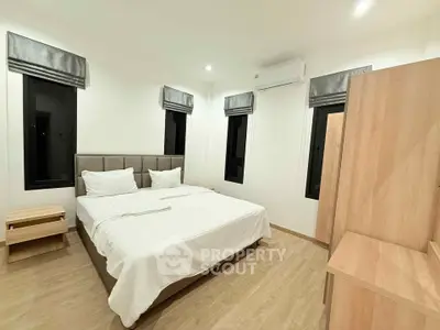 Spacious bedroom with modern decor and ample natural light