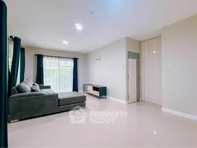 Spacious modern living room with large windows and sleek furniture