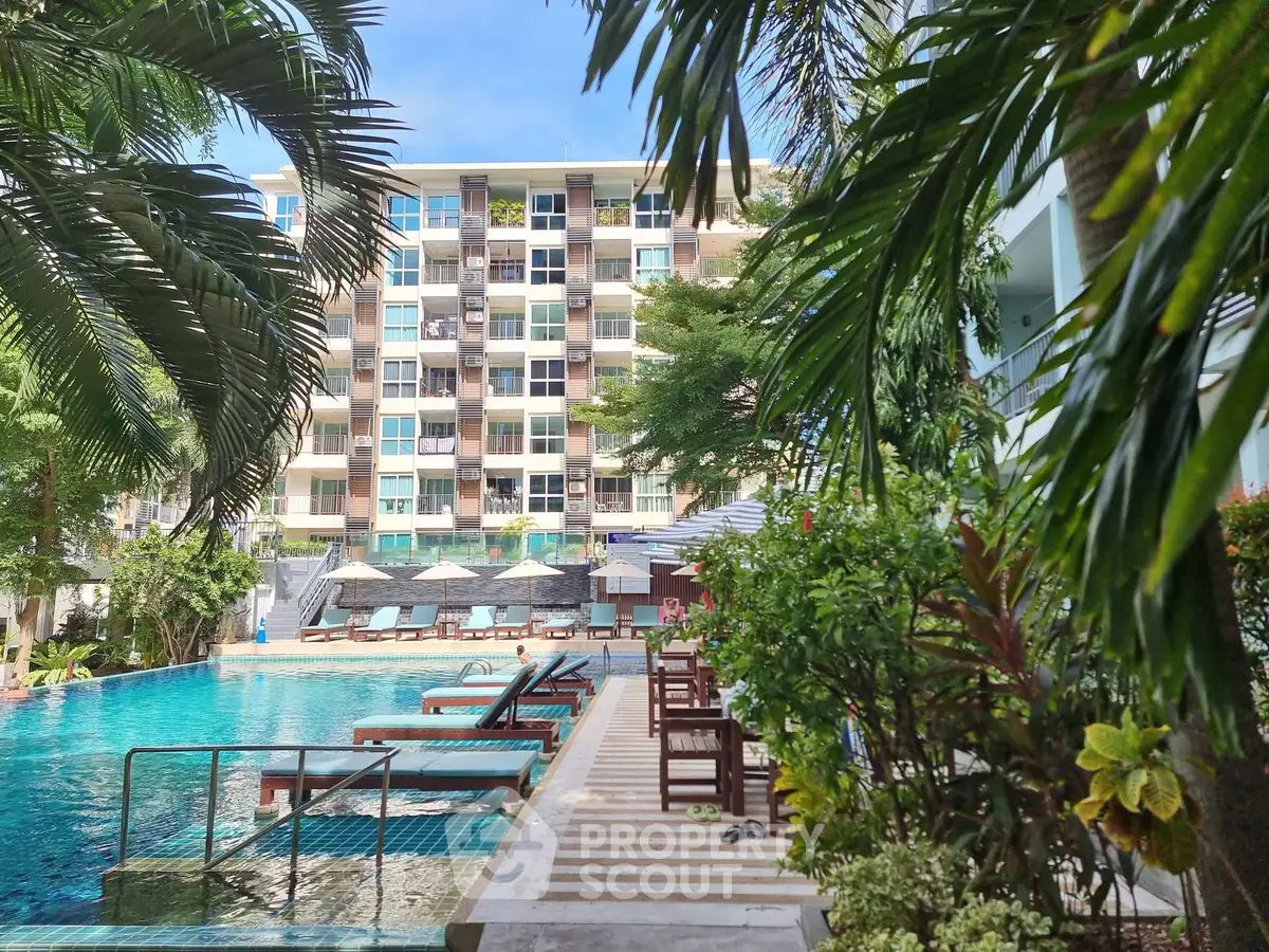 Luxurious apartment complex with stunning pool and lush greenery, perfect for relaxation and leisure.