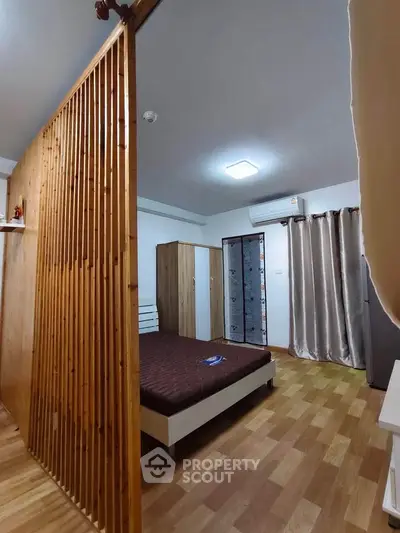 Modern bedroom with wooden partition and air conditioning