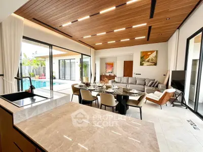 Luxurious open-plan living room with pool view and elegant dining area