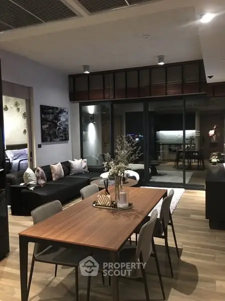 Modern open-plan living and dining area with stylish decor and cozy ambiance.