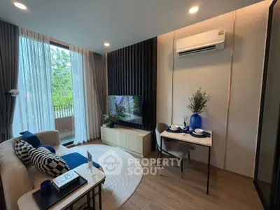 Modern living room with elegant decor, large window, and cozy seating area.