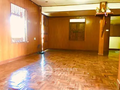 Spacious wooden interior living room with parquet flooring and natural light.