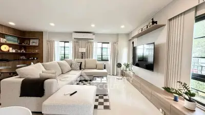 Spacious modern living room with stylish decor and large windows