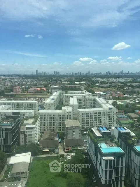 Stunning cityscape view from high-rise building showcasing urban skyline and lush greenery.