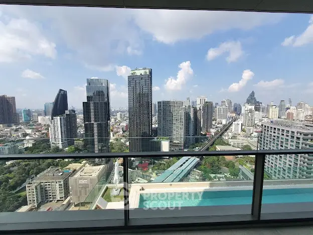 Stunning cityscape view from high-rise balcony with pool, perfect for urban living.
