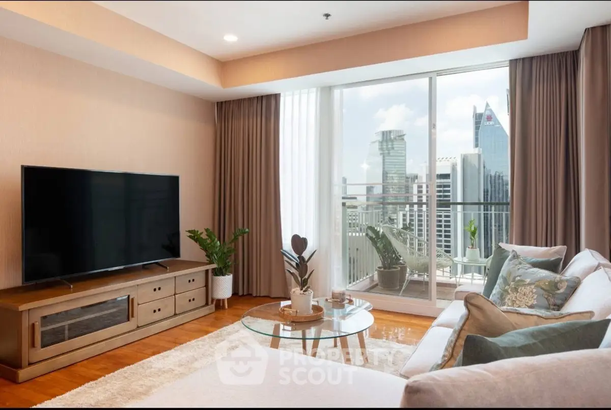 Modern living room with city view, large TV, and cozy seating area.
