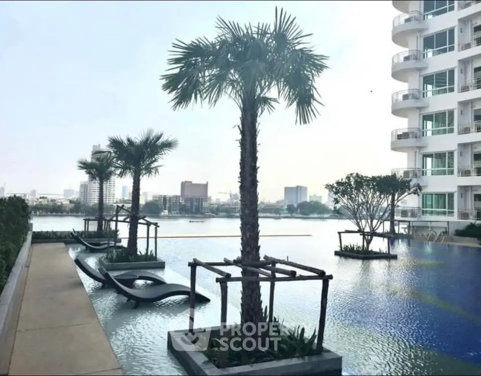 Luxurious apartment building with stunning poolside view and modern architecture.