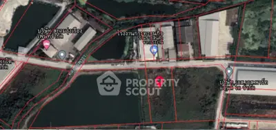 Aerial view of land plots with surrounding roads and buildings, ideal for development opportunities.