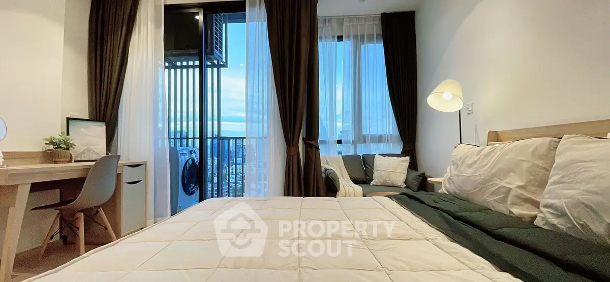 Modern bedroom with balcony view, stylish decor, and cozy ambiance in a high-rise apartment.