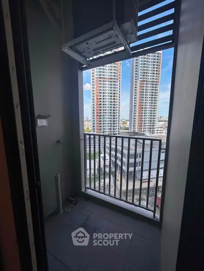 Compact balcony with city view in modern high-rise apartment