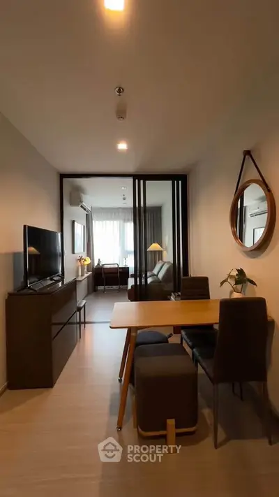 Modern living room with dining area and stylish decor in a cozy apartment.