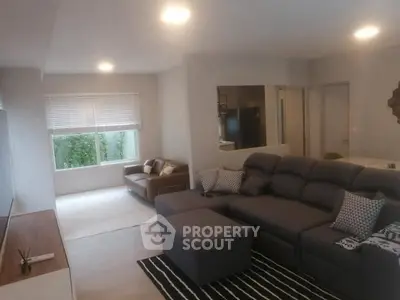 Spacious modern living room with cozy seating and natural light