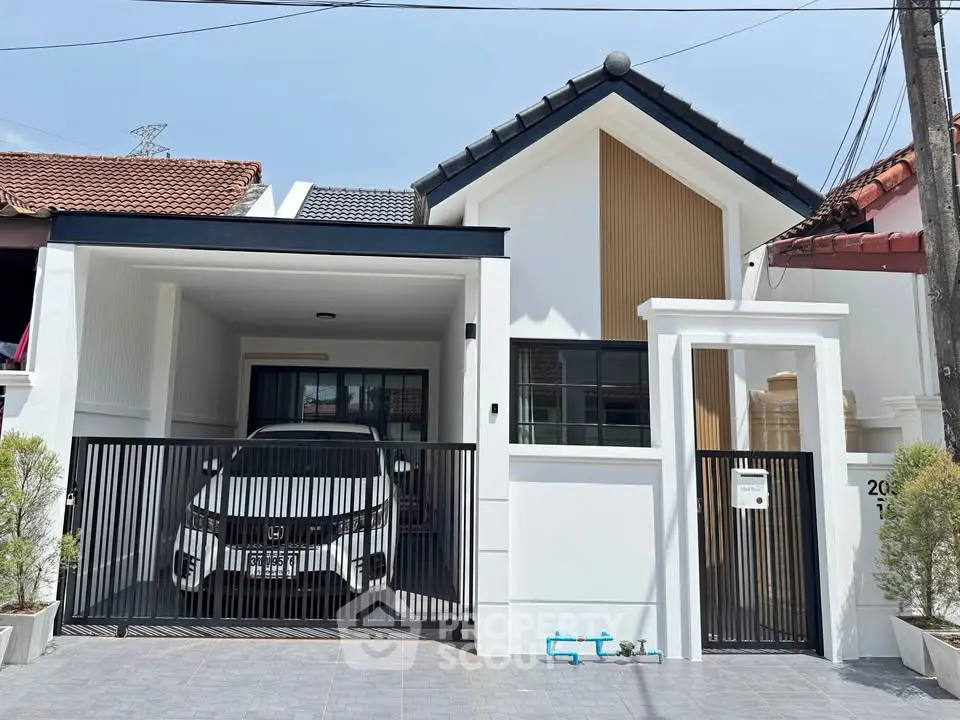 Modern townhouse with sleek design and gated parking area