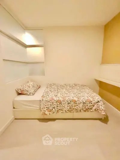 Cozy bedroom with modern design and floral bedding in a stylish apartment.