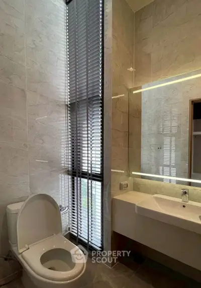 Modern bathroom with sleek design and large window for natural light.