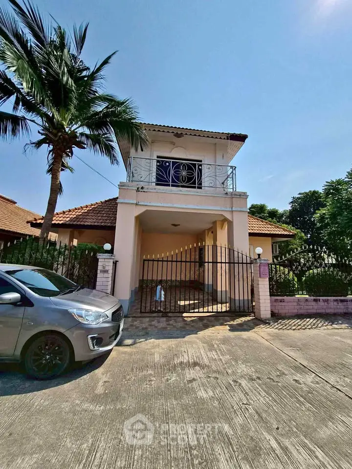 Charming villa with balcony and palm tree, perfect for serene living.
