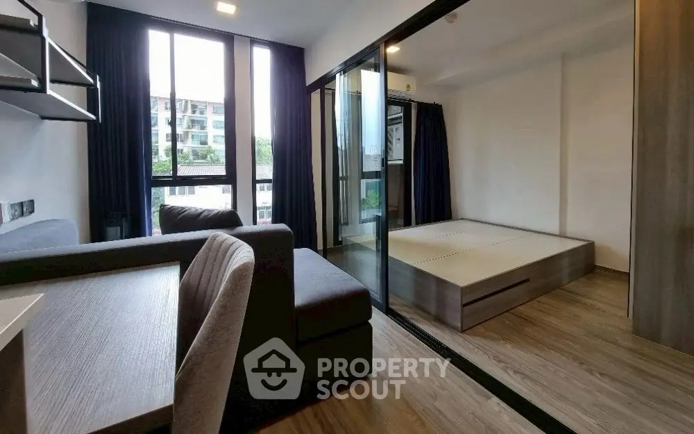 Modern studio apartment with sleek design and large windows for natural light