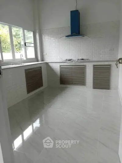 Modern kitchen with sleek cabinetry and large windows
