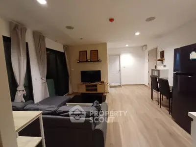 Modern living room with stylish decor and open layout, featuring cozy seating and dining area.