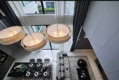 Luxurious modern living room with high ceilings and elegant dining area