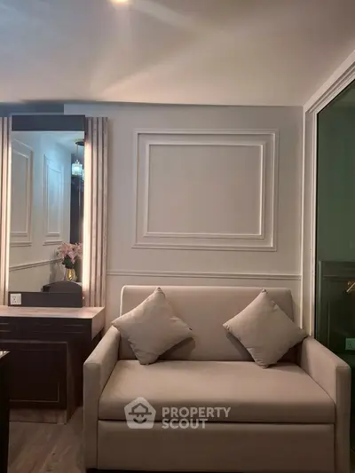 Elegant living room with stylish sofa and decorative wall paneling, perfect for modern urban living.