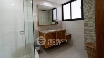 Modern bathroom with wooden vanity and large mirror
