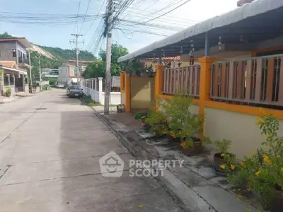 Charming residential street with colorful houses and lush greenery, perfect for family living.