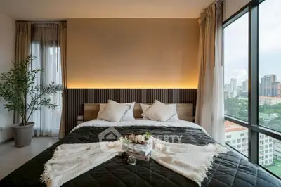 Luxurious bedroom with panoramic city view and elegant decor