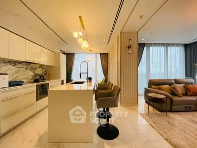 Luxurious open-plan kitchen and living room with modern design and elegant lighting.