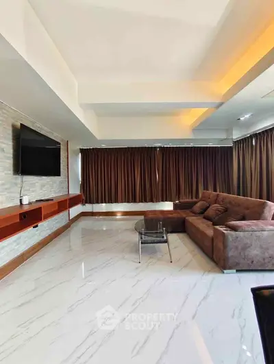 Spacious modern living room with sleek marble flooring and cozy sectional sofa.