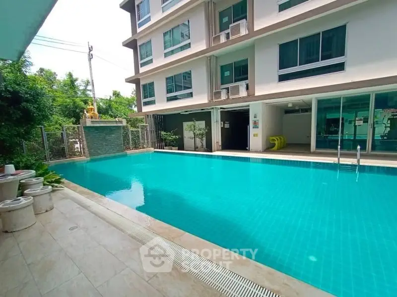 Luxurious apartment complex with a pristine swimming pool and modern amenities.