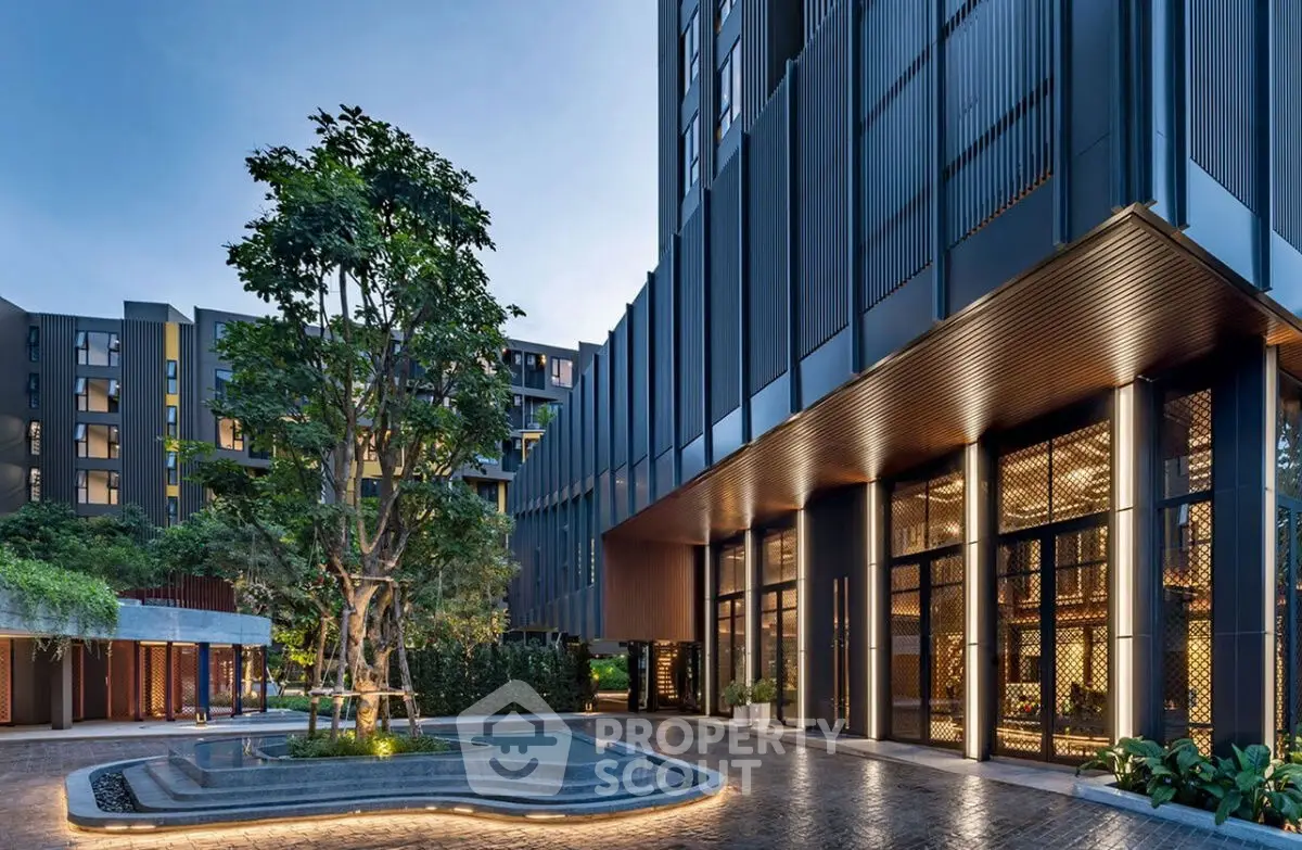 Modern luxury apartment building entrance with elegant design and lush greenery