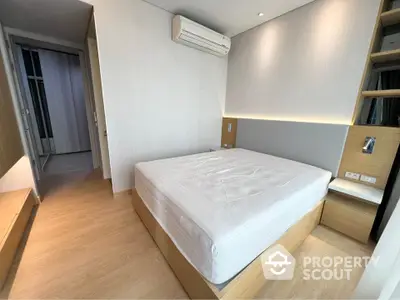 Modern minimalist bedroom with built-in storage and air conditioning