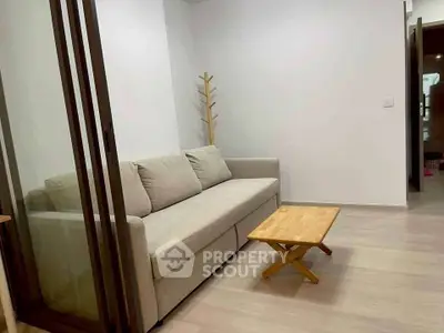 Modern living room with cozy sofa and wooden coffee table in minimalist design.