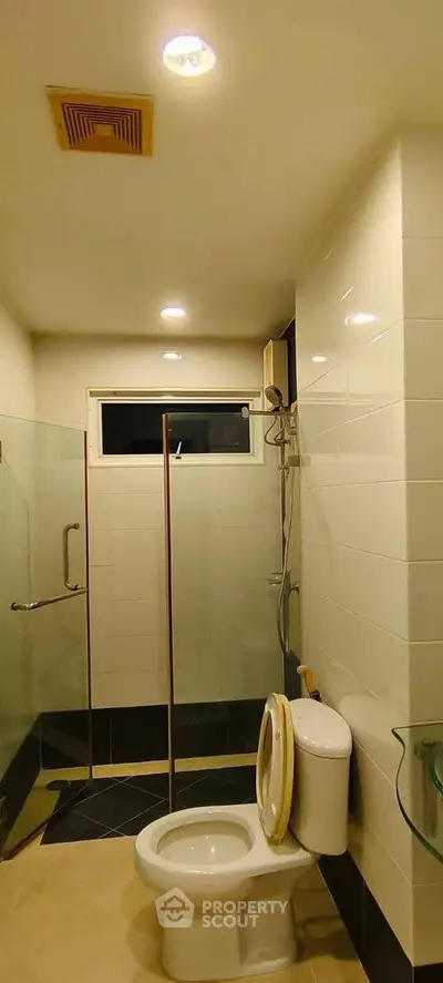 Modern bathroom with glass shower enclosure and sleek fixtures
