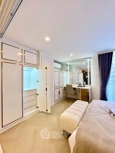 Luxurious bedroom with elegant built-in wardrobe and cozy seating area