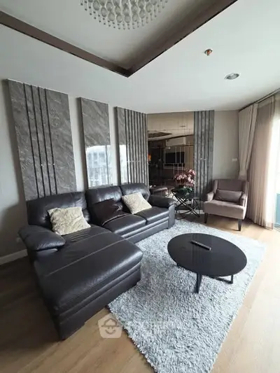 Modern living room with stylish decor, leather sofa, and elegant lighting in a contemporary apartment.