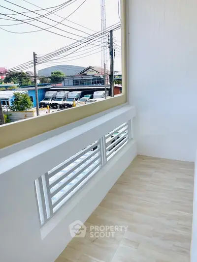 Spacious balcony with modern railing and city view, perfect for relaxation.
