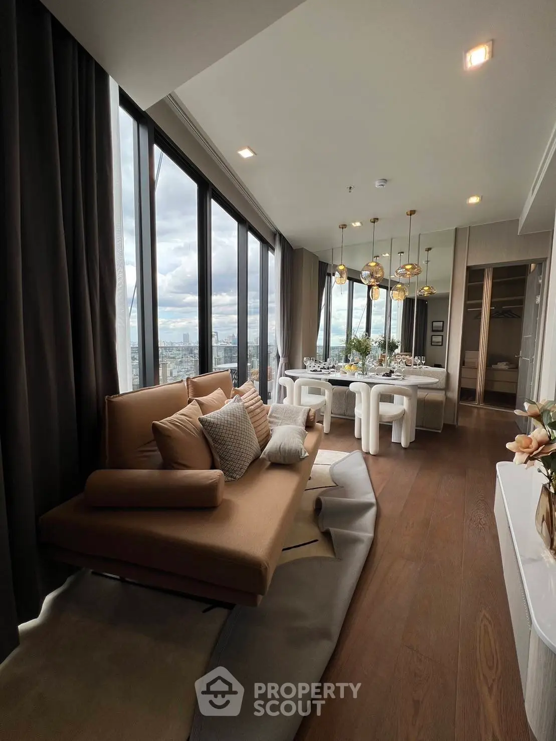 Luxurious modern living room with panoramic city views and elegant dining area.