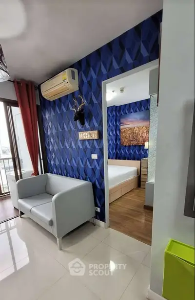 Modern apartment interior with blue geometric wallpaper and cozy furniture
