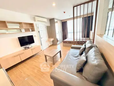 Modern studio apartment with open layout, featuring a cozy living area and stylish bedroom.