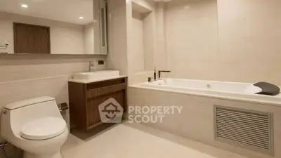 Luxurious modern bathroom with sleek design and spacious bathtub.