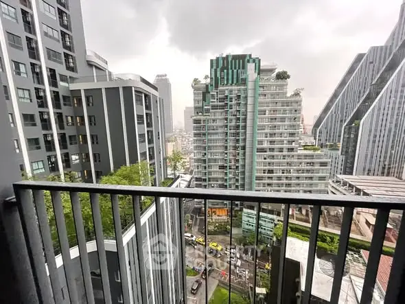 Stunning urban view from a high-rise balcony showcasing modern architecture and cityscape.