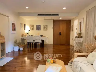 Spacious living room with elegant dining area and wooden flooring